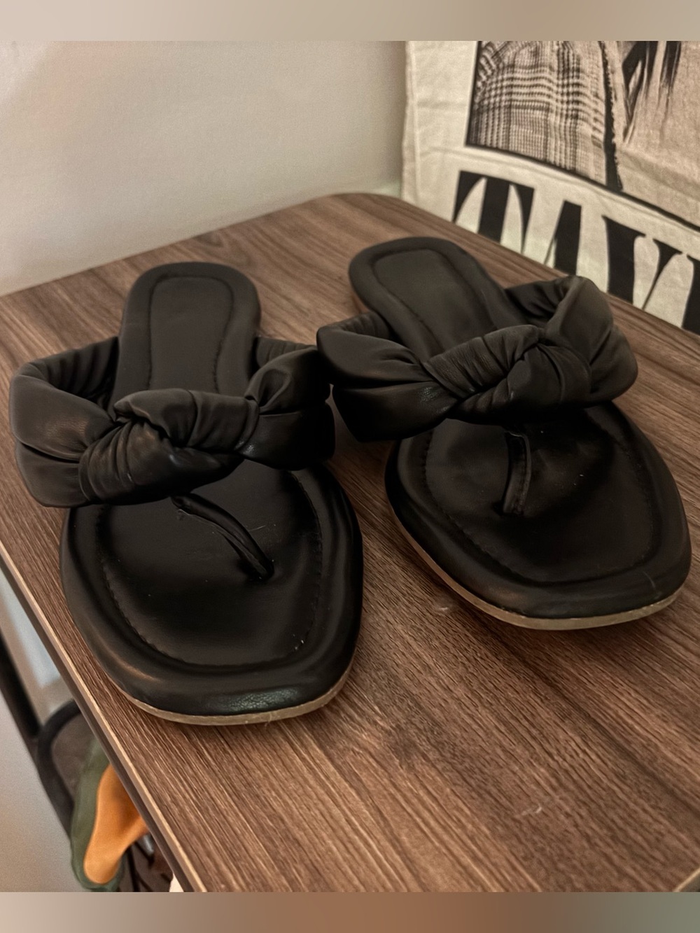 black leather flip flops with knot